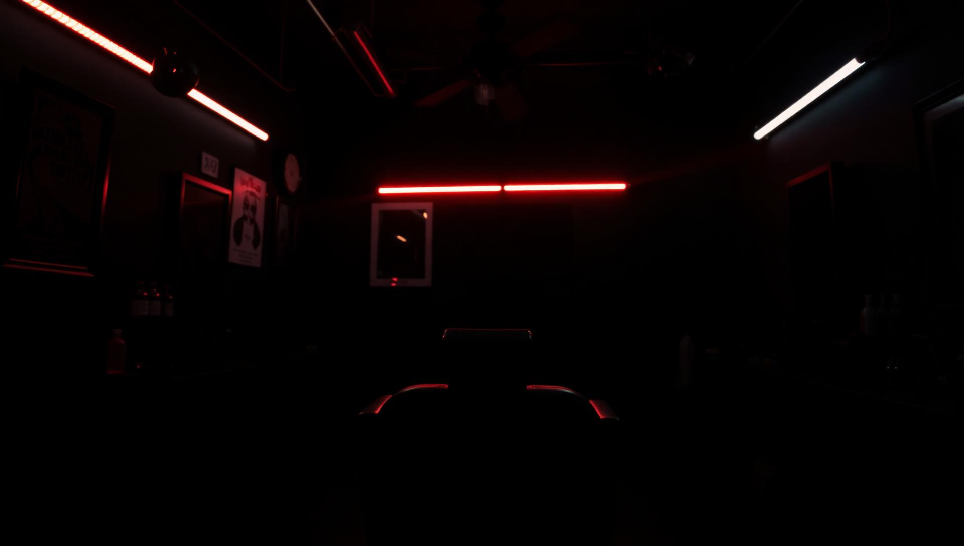 Inside Blaqink Tattoos studio with red neon lighting